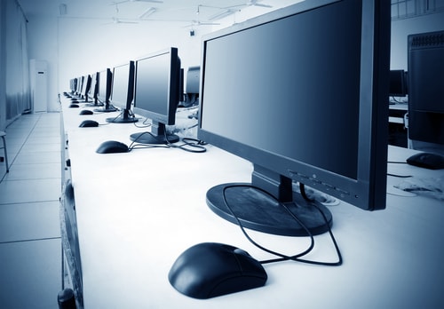 Several computer monitors on a desk