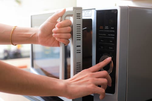 Person opening a microwave