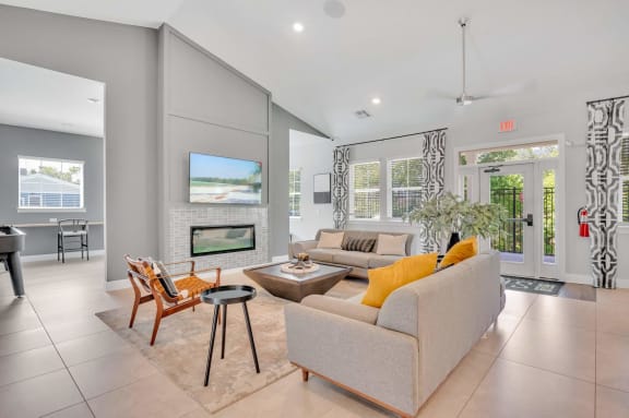 a living room with a couch and a chair and a fireplace at spire luxury apartments in charlotte, nc