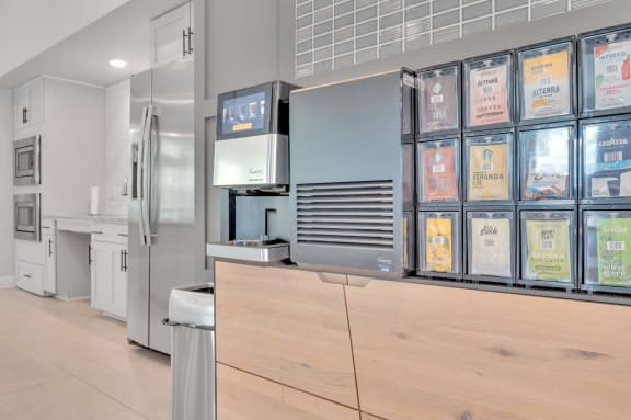 a kitchen with a counter top and with different types of coffee at spire apartments in charlotte nc