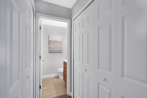 a doorway into a bathroom with a toilet and sink at Stonewater Apartments, Louisville, KY