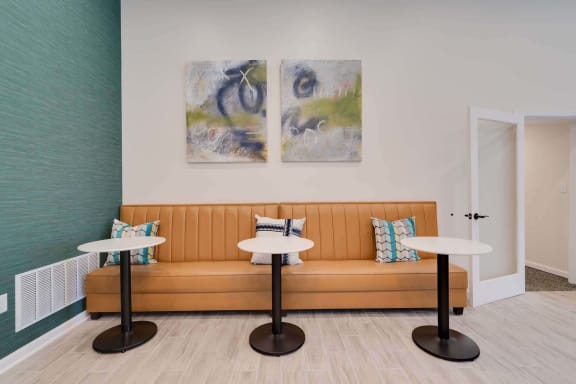 a seating area with a couch and two tables at at Station JTown, Kentucky, 40299