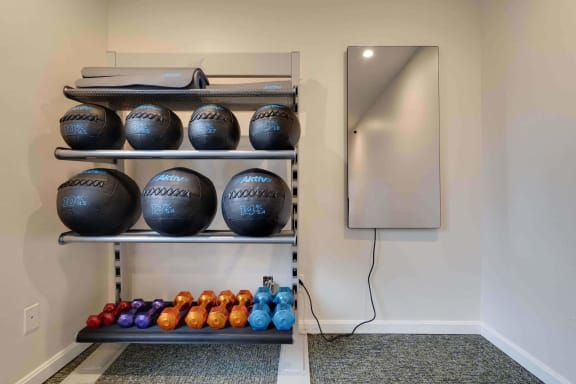 a bowling alley with bowling balls on the shelves and a bowling ball dispenser on the wall at Station JTown, Kentucky, 40299