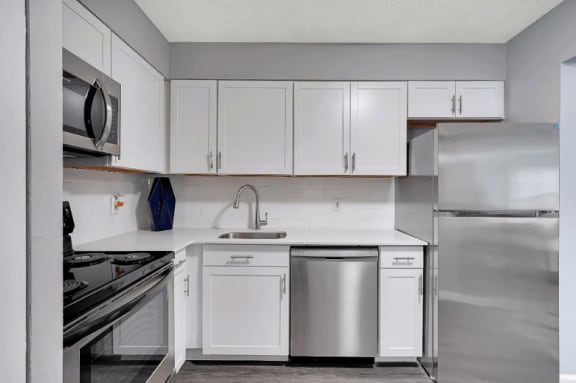 a kitchen with white cabinets and stainless steel appliances at Enclave at Breckenridge Apartments, Louisville, KY, 40220