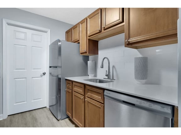 a kitchen with a sink and a refrigerator at Stonewater Apartments, Louisville, KY