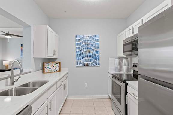 A kitchen with white cabinets and a stainless steel oven.at Elan Apartments, Florida, 32547