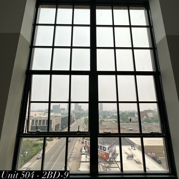 a large window with a view of a city street