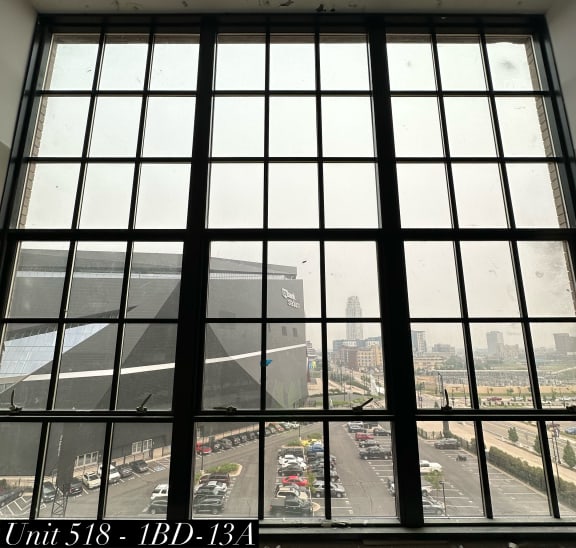 a window with a view of a parking lot and a city