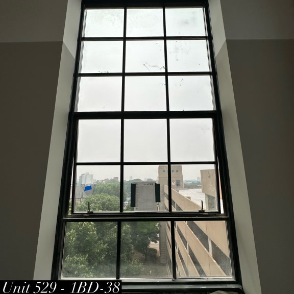 a large window in a room with a view of a building