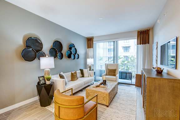 A living room with a white couch and a yellow chair.