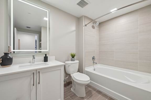 A white bathroom with a toilet, sink, and bathtub.