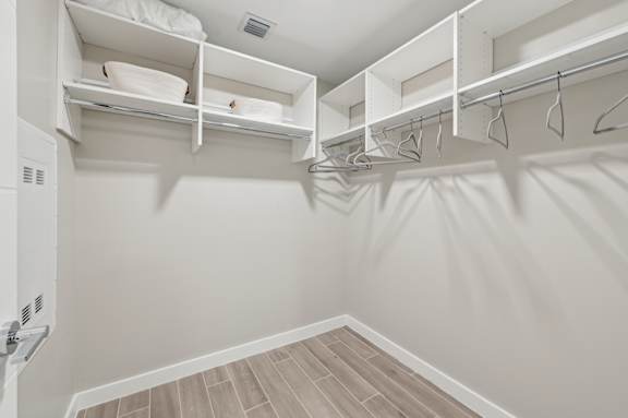 A white closet with shelves and hangers.