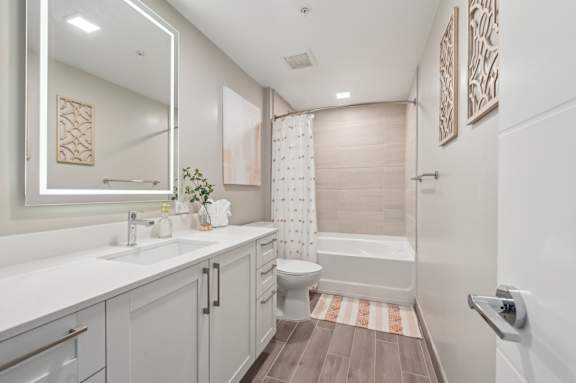 A bathroom with a white sink and a white bathtub.