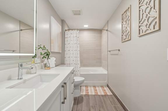 A bathroom with a white sink and a white toilet.