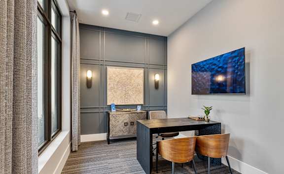 A modern dining room with a wooden table and chairs at Mayla Pompano, Pompano Beach