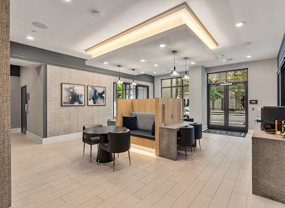 A modern office lobby with a reception desk and seating area at Mayla Pompano, Pompano Beach, FL, 33062