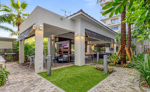 A modern house with a patio and a barbecue area at Mayla Pompano, Pompano Beach, 33062