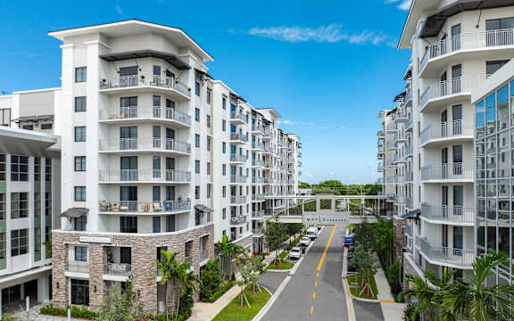 A street view of a residential area with apartment buildings on both sides at Mayla Pompano, Pompano Beach, FL, 33062