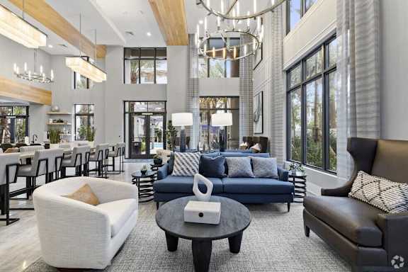 a living room with couches and chairs and a table at Mayla Pompano, Pompano Beach, 33062