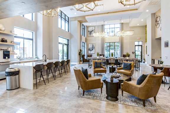 A spacious living room with a bar area and a dining table at Mayla Pompano, Pompano Beach, FL, 33062