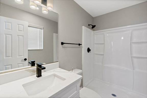 a bathroom with a sink and a shower and a toilet at Ocean Breeze Terrace Apartment, Huntington Beach, California
