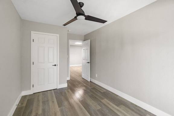 an empty room with a ceiling fan and a white door at Ocean Breeze Terrace Apartment, Huntington Beach