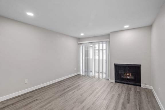 a living room with a fireplace and a window