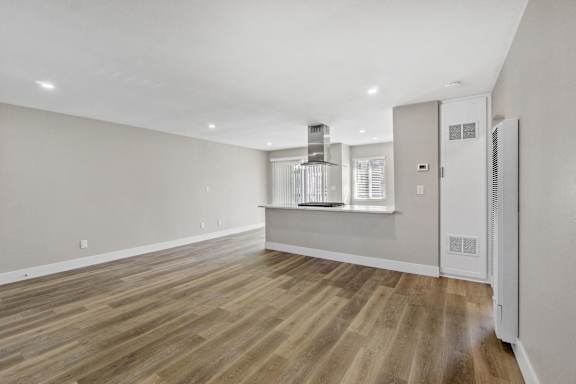 A room with wooden floors and a white ceiling at Ocean Breeze Terrace Apartment, California, 92648