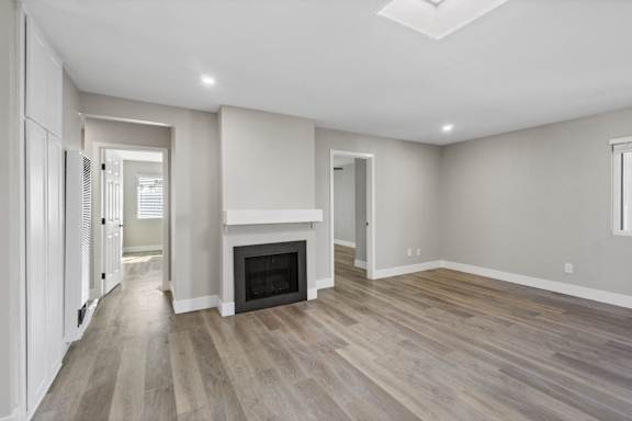 a living room with a fireplace and wooden floors at Ocean Breeze Terrace Apartment, Huntington Beach, 92648