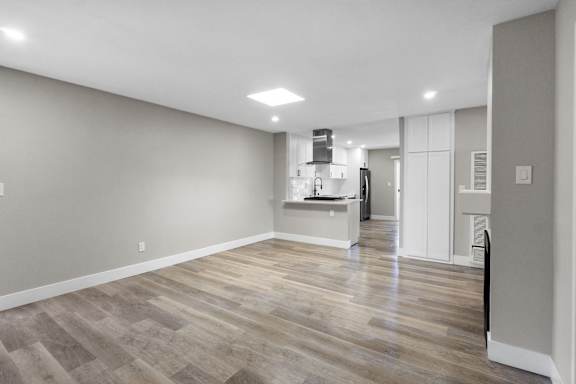 a renovated living room and kitchen in a new home at Ocean Breeze Terrace Apartment, Huntington Beach, CA, 92648