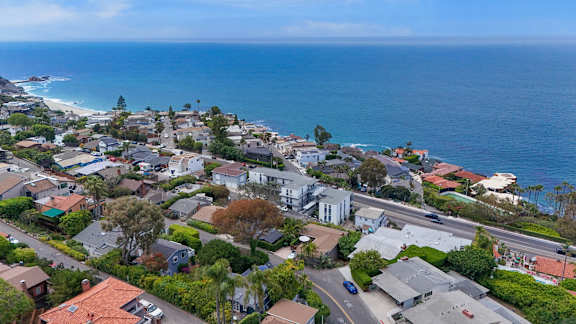 A coastal residential area with houses and a road.