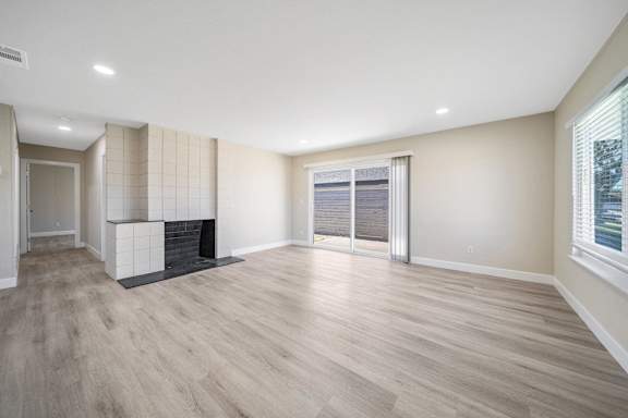 a living room with a fireplace and a sliding glass door at Wescove Apartments
