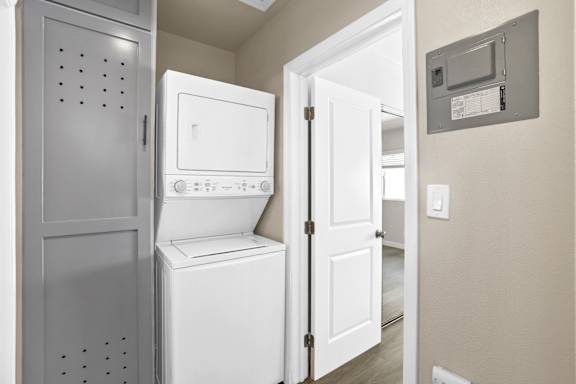 a laundry room with a washer and dryer and a door to a door
