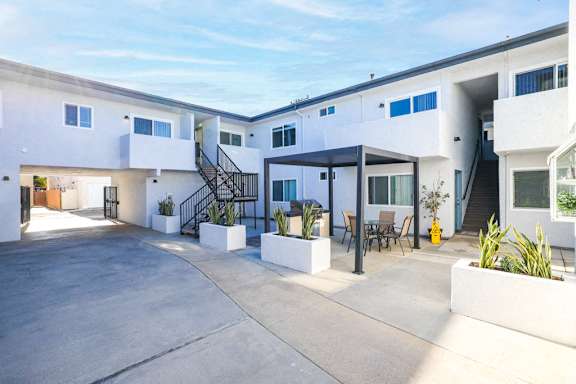 A modern white building with a black staircase at 316 Beach Apartments
