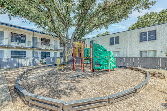 Community playground area with colorful equipment at Northwood Heights Apartments, Dallas, TX 75248