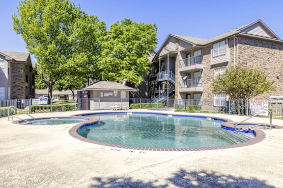 A swimming pool in front of a residential building.