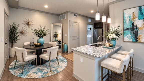 A modern kitchen with a dining table and chairs.
