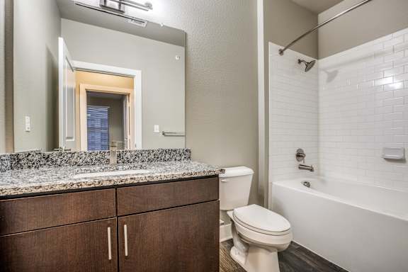 A bathroom with a toilet, sink, and bathtub.