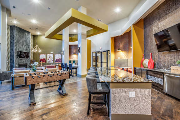 A modern kitchen with a dining table and chairs.