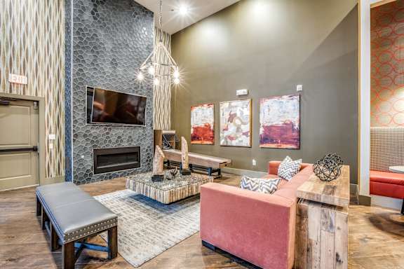 A living room with a fireplace and a TV above it.
