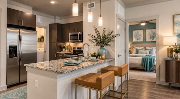 A kitchen with a marble countertop and stainless steel appliances.
