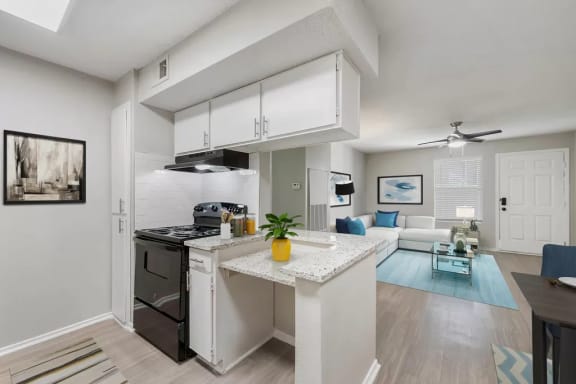 a kitchen and living room with a counter top