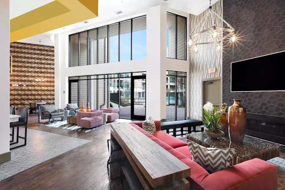 A modern living room with a wooden floor and a red couch.