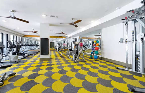 A gym with a yellow and black floor.