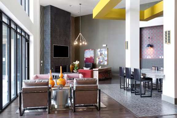 A modern living room with a grey sofa and a TV.