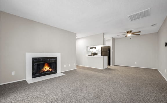 a living room with a fireplace and a ceiling fan
