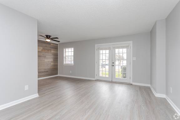 A room with a sliding door and a ceiling fan.at Liberty Crossing, Jacksonville, 28540