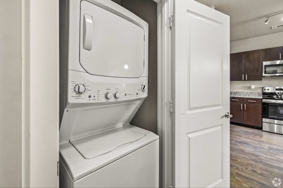 A white oven with a microwave built in is in a kitchen.