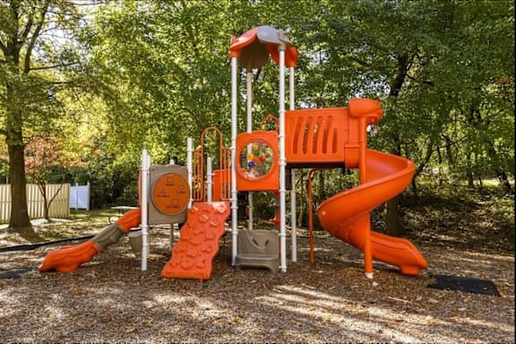 A playground with a slide and a climbing structure.
