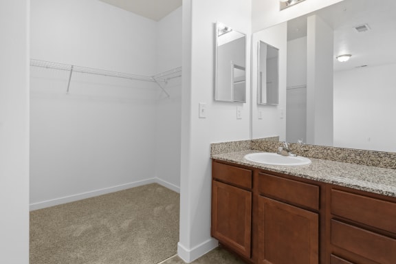 an empty bathroom with a sink and a mirror